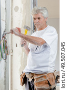 Chiseling at an old wall. Стоковое фото, агентство Ingram Publishing / Фотобанк Лори