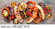 Grilled sausages fried with pear and vegetables. Autumn food.. Grilled sausages with vegetables. Стоковое фото, агентство Ingram Publishing / Фотобанк Лори