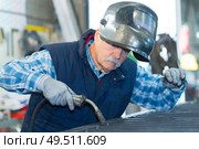 senior man using blow torch. Стоковое фото, агентство Ingram Publishing / Фотобанк Лори