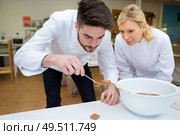 portrait of chefs melting caramel sauce. Стоковое фото, агентство Ingram Publishing / Фотобанк Лори
