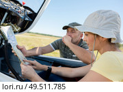 woman looking at a map in private jet. Стоковое фото, агентство Ingram Publishing / Фотобанк Лори