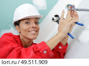 portrait of female electrician holding cable cutters. Стоковое фото, агентство Ingram Publishing / Фотобанк Лори