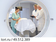 View of medical team through circular mri scanner. Стоковое фото, агентство Ingram Publishing / Фотобанк Лори