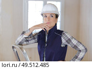 contemplative woman in renovation property. Стоковое фото, агентство Ingram Publishing / Фотобанк Лори