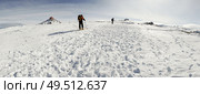 Spain, Andalusia, Granada. Panorama of Ski resort of Sierra Nevada in winter, full of snow, with unrecognizable people doing cross-country skiing. Travel and sports concepts.. People doing cross-country skiing in Sierra Nevada. Стоковое фото, агентство Ingram Publishing / Фотобанк Лори