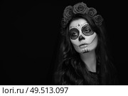 Portrait of a woman with sugar skull makeup over black background. Halloween costume and make-up. Black and white Portrait of Calavera Catrina. Стоковое фото, агентство Ingram Publishing / Фотобанк Лори