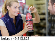 female worker in a store that sells fire extinguishers. Стоковое фото, агентство Ingram Publishing / Фотобанк Лори
