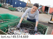 female working in the junkyard segregating the wires. Стоковое фото, агентство Ingram Publishing / Фотобанк Лори