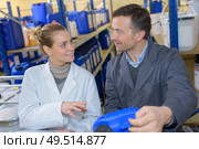 male and female factory workers talking during shift. Стоковое фото, агентство Ingram Publishing / Фотобанк Лори