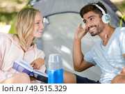couple listening to music while camping. Стоковое фото, агентство Ingram Publishing / Фотобанк Лори