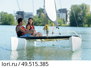 a young couple on catamaran. Стоковое фото, агентство Ingram Publishing / Фотобанк Лори