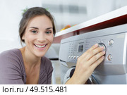 happy housewife woman in laundry room with washing machine. Стоковое фото, агентство Ingram Publishing / Фотобанк Лори