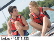 young couple steering a catamaran. Стоковое фото, агентство Ingram Publishing / Фотобанк Лори