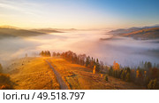 Beautiful November sunrise over mountain foggy valley. Awesome alpine highlands. Wide panorama of beautiful autumn Carpathian mountains, at early morning. Europe, Carpathians, Ukraine. Стоковое фото, агентство Ingram Publishing / Фотобанк Лори
