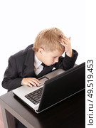 Little boy in a business suit with the laptop in the confusion, isolated. Стоковое фото, агентство Ingram Publishing / Фотобанк Лори