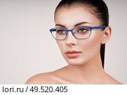 Woman with long eyelashes in eyeglasses. Vision correction. Poor eyesight. Spectacle frame. Makeup, cosmetics, beauty. Close up, macro. Стоковое фото, агентство Ingram Publishing / Фотобанк Лори