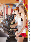 Some persons practise on racetracks in sports club. Стоковое фото, агентство Ingram Publishing / Фотобанк Лори