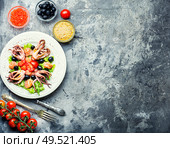 Appetizing salad with calamari, salmon and vegetables.. Salad with squid and seafood. Стоковое фото, агентство Ingram Publishing / Фотобанк Лори