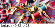 Sewing tools, scissors, buttons and threads on fabric.Sew. Sewing accessories and fabric. Стоковое фото, агентство Ingram Publishing / Фотобанк Лори