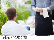 A young man makes a restaurant reservation. Стоковое фото, агентство Ingram Publishing / Фотобанк Лори
