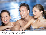 The smiling friends who are in pool look afar. Стоковое фото, агентство Ingram Publishing / Фотобанк Лори