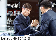 Two businessmen struggle on a forward background. Стоковое фото, агентство Ingram Publishing / Фотобанк Лори