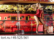 The attractive girl dances a striptease in club. Стоковое фото, агентство Ingram Publishing / Фотобанк Лори