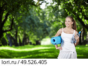 Young girl with a bottle of water and gymnastic mat. Стоковое фото, агентство Ingram Publishing / Фотобанк Лори