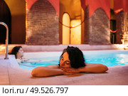 Two women enjoying Arabic baths Hammam in Granada, Andalusia, Spain. Elvira baths. Hot water pool.. Two women enjoying Arabic baths Hammam in Granada. Стоковое фото, агентство Ingram Publishing / Фотобанк Лори