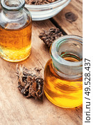 Medicinal tincture from the roots and rhizomes of valerian.Alternative medicine. Bottle of herbal tincture. Стоковое фото, агентство Ingram Publishing / Фотобанк Лори