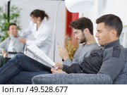men on the waiting room. Стоковое фото, агентство Ingram Publishing / Фотобанк Лори