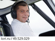 pilot in cockpit of helicopter during flight. Стоковое фото, агентство Ingram Publishing / Фотобанк Лори