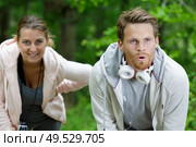 young couple taking a breather from exercise outdoors. Стоковое фото, агентство Ingram Publishing / Фотобанк Лори