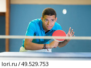 young sports man tennis player is playing ping pong. Стоковое фото, агентство Ingram Publishing / Фотобанк Лори