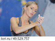 woman applying chalk on her hands before climbing. Стоковое фото, агентство Ingram Publishing / Фотобанк Лори