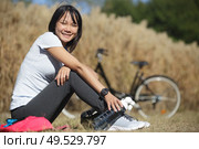 biker woman refreshing drinking water at her morning exercise. Стоковое фото, агентство Ingram Publishing / Фотобанк Лори