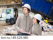 workers in a recycle center lorry tipping in background. Стоковое фото, агентство Ingram Publishing / Фотобанк Лори