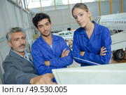 close up of apprentices and aircraft technician apprentice. Стоковое фото, агентство Ingram Publishing / Фотобанк Лори