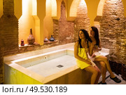 Two women enjoying Arabic baths Hammam in Granada, Andalusia, Spain. Elvira baths. Cold water pool. Two women enjoying Arabic baths Hammam in Granada. Стоковое фото, агентство Ingram Publishing / Фотобанк Лори