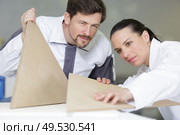 decorators are examining wooden templates. Стоковое фото, агентство Ingram Publishing / Фотобанк Лори
