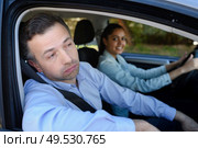 bored instructor teaching woman to drive. Стоковое фото, агентство Ingram Publishing / Фотобанк Лори