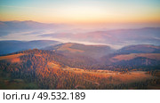Aerial panorama of beautiful autumn mountains. Sunrise over mountain foggy valley. Misty woodland in the morning. Carpathians, Ukraine. Стоковое фото, агентство Ingram Publishing / Фотобанк Лори