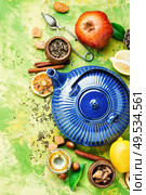 Natural ingredients for tea.Porcelain blue teakettle.Useful tea with lemon.. Tea with lemon. Стоковое фото, агентство Ingram Publishing / Фотобанк Лори