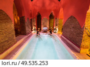 Two women enjoying Arabic baths Hammam in Granada, Andalusia, Spain. Elvira baths. Hot water pool.. Two women enjoying Arabic baths Hammam in Granada. Стоковое фото, агентство Ingram Publishing / Фотобанк Лори