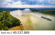 Tourist ship on Danube river between Budapest and Visegrad. Summer vacations aerial view. Sunny and rainy mixed weather. Стоковое фото, агентство Ingram Publishing / Фотобанк Лори