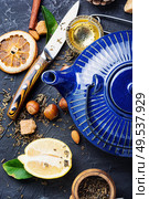 Natural ingredients for tea.Porcelain blue teakettle.Useful tea with lemon.. Tea with lemon. Стоковое фото, агентство Ingram Publishing / Фотобанк Лори