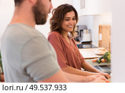 Modern and young couple cooking together at home. Стоковое фото, агентство Ingram Publishing / Фотобанк Лори