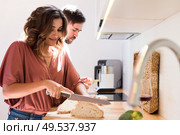 Modern and young couple cooking together at home. Стоковое фото, агентство Ingram Publishing / Фотобанк Лори