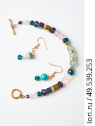 gold jewerly braslete with semiprecious and cristal at white background. Стоковое фото, агентство Ingram Publishing / Фотобанк Лори