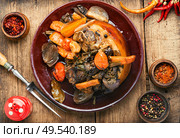 Roasted pork knuckle eisbein with vegetables on wooden background.Braised pork leg. Roasted pork knuckle. Стоковое фото, агентство Ingram Publishing / Фотобанк Лори